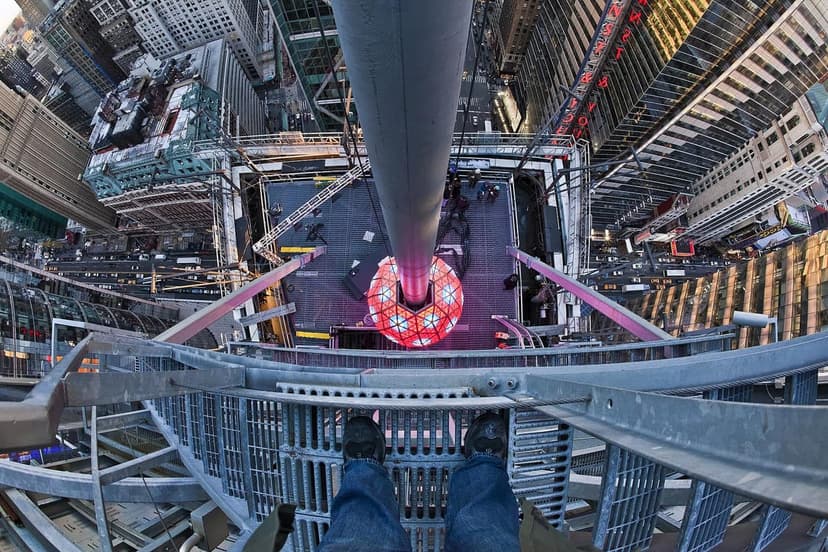High angle fisheye view of the Times Square New Year's Eve Ball from above, with a person's feet on a metal platform.